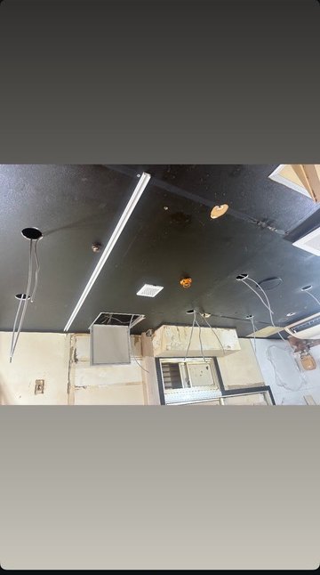 天井から照明用の配線を出した工事中の店舗