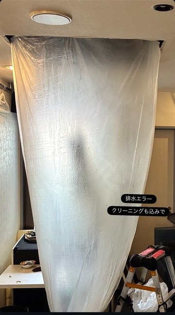 天井カセット型エアコンの下に養生シートを張って洗浄している様子